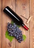 Red wine bottle and bunch of red grapes