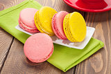 Colorful macaron cookies and cup of coffee