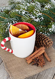 Christmas mulled wine with spices and snowy fir tree