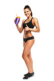 athletic young woman with protein shake bottle