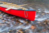 red canoe on a shallow river