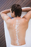 Man on massage table with powder on back at spa center