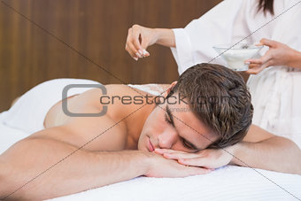Man receiving treatment at spa center