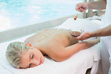 Attractive woman receiving spa treatment with honey