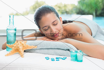 Woman lying on massage table at spa center