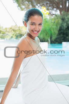 Beautiful woman sitting with eyes closed at spa center