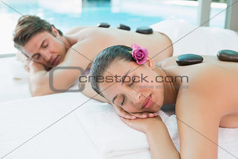 Couple enjoying stone massage at health farm