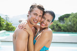 Romantic couple by swimming pool on a sunny day