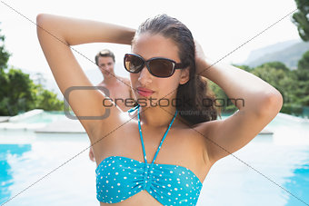 Beautiful woman by swimming pool on a sunny day