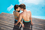Romantic young couple by swimming pool