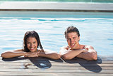 Smiling young couple in swimming pool