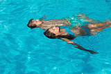 Relaxed young couple in swimming pool
