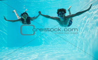 Couple wearing snorkels in swimming pool