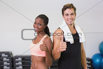Personal trainer and client smiling at camera