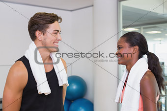 Personal trainer and client smiling at each other