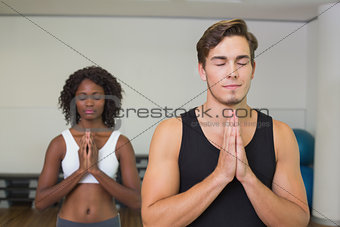 Fit couple standing with hands together