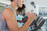Fit man and woman running on treadmill