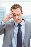 Businessman with severe headache at office