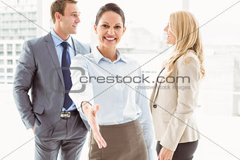 Cheerful businesswoman with colleagues at office