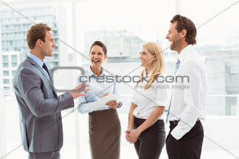 Cheerful colleagues in discussion at office