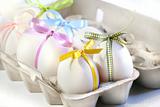 White eggs with colored ribbons 