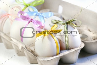 White eggs with colored ribbons 