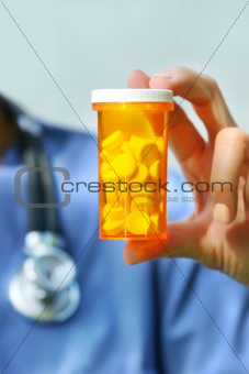 Nurse holding bottle of pills