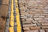 Modern (no parking) double yellow lines along ancient cobble stones