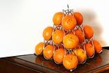 pyramid of oranges on a table