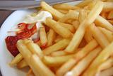 French fries with condiments