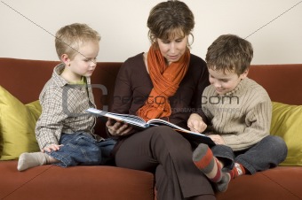 Mother And Two Sons Reading A Book 2