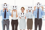 Business people holding happy smileys