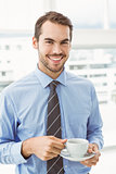 Smiling businessman during break time in office