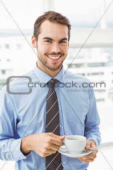 Smiling businessman during break time in office