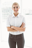 Beautiful businesswoman with arms crossed in office