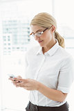 Businesswoman text messaging in office