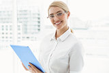 Businesswoman with clipboard in office