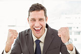 Cheerful businessman cheering in office
