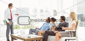 Businessman giving presentation in office