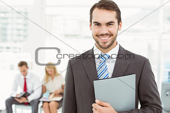 Businessman against people waiting for interview