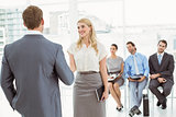 Businesspeople in front of people waiting for interview