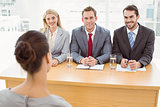 Business people interviewing woman