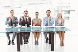 Interview panel clapping hands in office