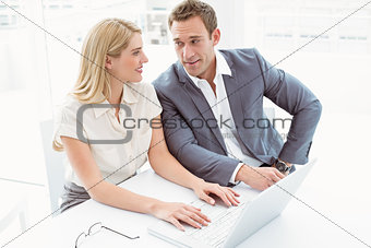 Business people using laptop in office