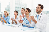 Doctors clapping hands in meeting