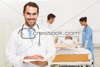 Doctor with colleagues and patient behind