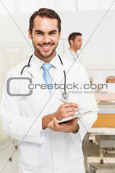 Doctor with colleague and patient behind