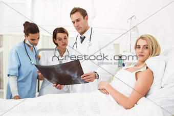 Portrait of doctors and patient with x-ray