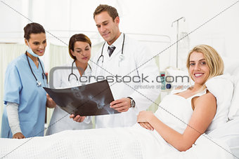 Portrait of doctors and patient with x-ray