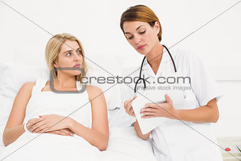 Doctor explaining report to female patient